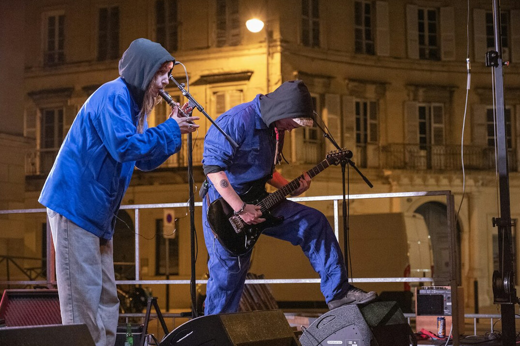 Two musicians rehearsing together on stage with instruments