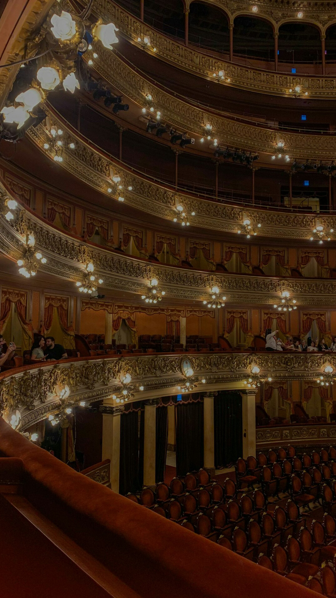 Elegant theatre stage with warm lighting before a cultural event