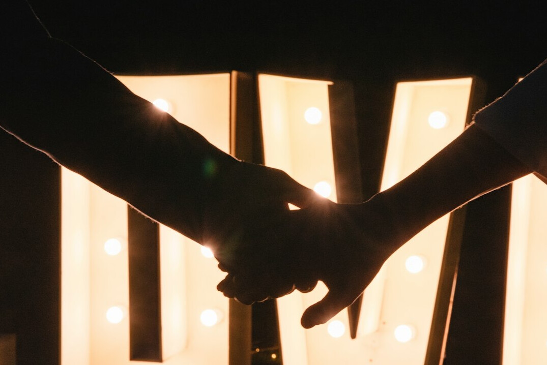 Two people shaking hands warmly after an event