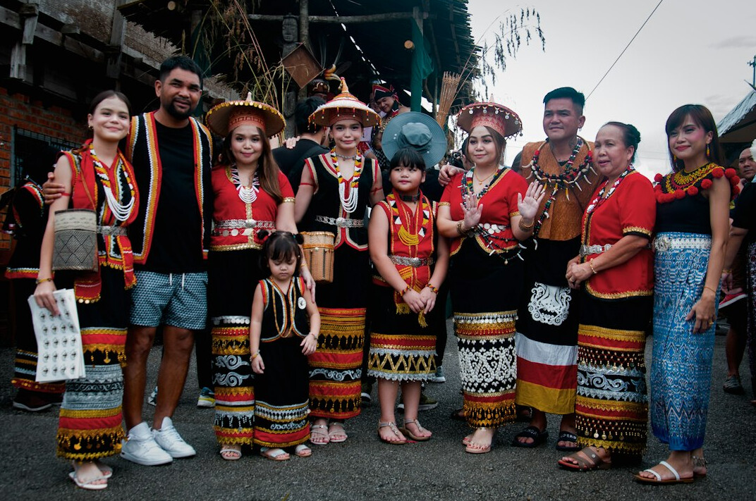 Small group of people posing together at a cultural event